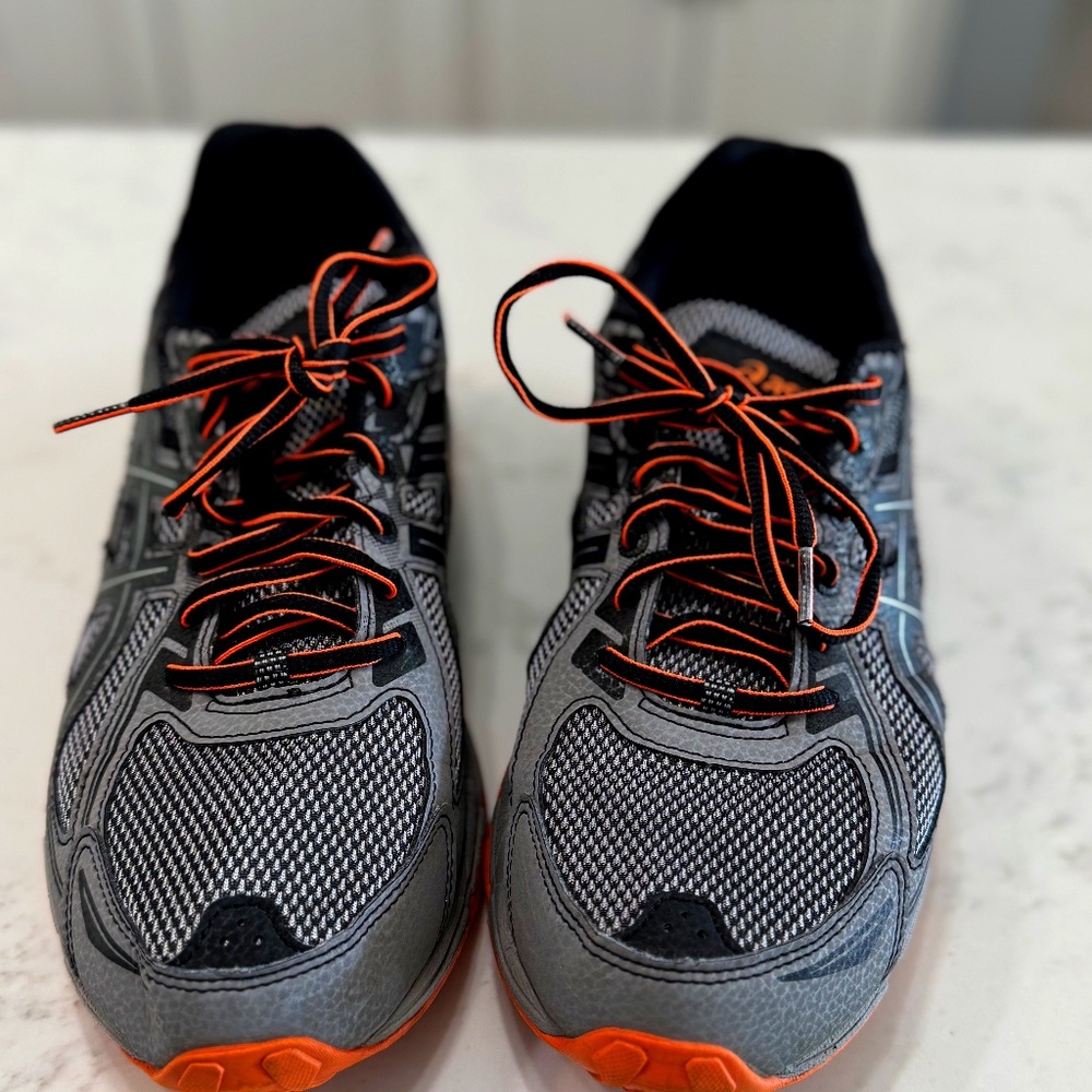 Mens Asics size 11 Tennis shoes; Black, grey, with orange Accents